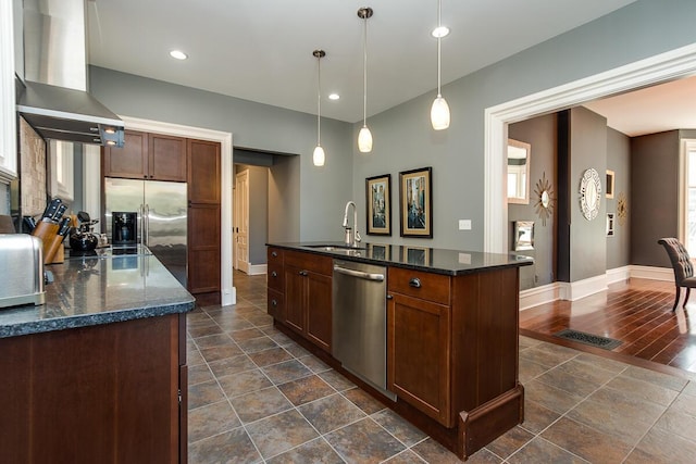 22 Jefferson Ave SE, Grand Rapids, MI 49503 - kitchen featuring stainless steel appliances, wall chimney range hood, a sink, baseboards, and hanging light fixtures