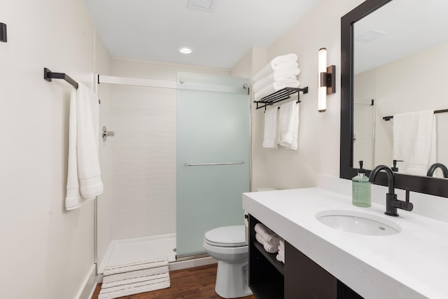 22 Jefferson Ave SE, Grand Rapids, MI 49503 - bathroom with vanity, toilet, a shower stall, wood finished floors, and recessed lighting