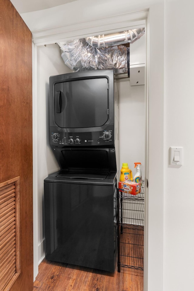 22 Jefferson Ave SE, Grand Rapids, MI 49503 - laundry area featuring stacked washing machine and dryer and wood finished floors