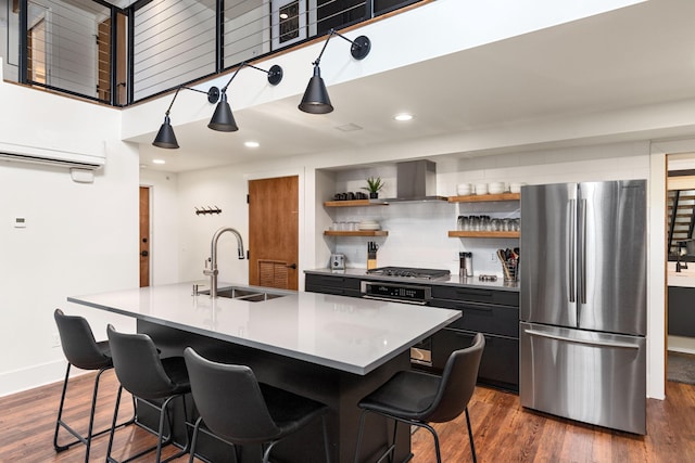 22 Jefferson Ave SE, Grand Rapids, MI 49503 - kitchen featuring appliances with stainless steel finishes, a sink, ventilation hood, a kitchen bar, and dark cabinets