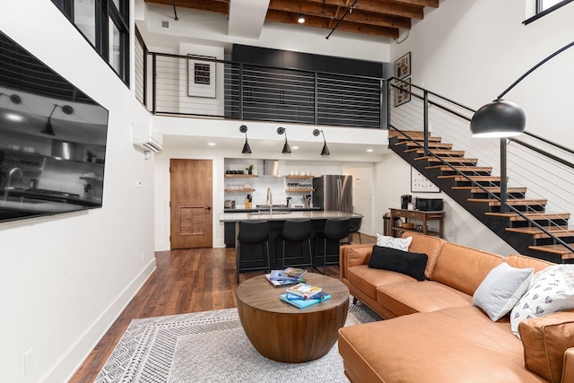 22 Jefferson Ave SE, Grand Rapids, MI 49503 - living area featuring a high ceiling, stairs, dark wood-style floors, baseboards, and a wall mounted AC