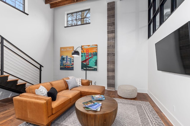22 Jefferson Ave SE, Grand Rapids, MI 49503 - living area featuring stairway, wood finished floors, a towering ceiling, baseboards, and beam ceiling