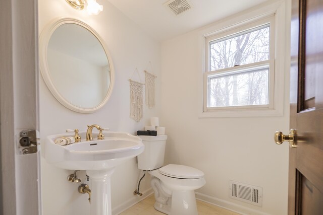 16230 Woodcrest Dr, Spring Lake, MI 49456 - half bathroom with visible vents, toilet, and baseboards