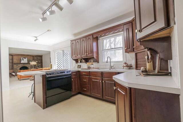 16230 Woodcrest Dr, Spring Lake, MI 49456 - kitchen featuring tasteful backsplash, electric range oven, light countertops, rail lighting, and a peninsula