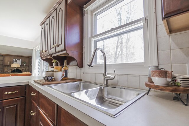 16230 Woodcrest Dr, Spring Lake, MI 49456 - kitchen with backsplash, a sink, light countertops, and plenty of natural light