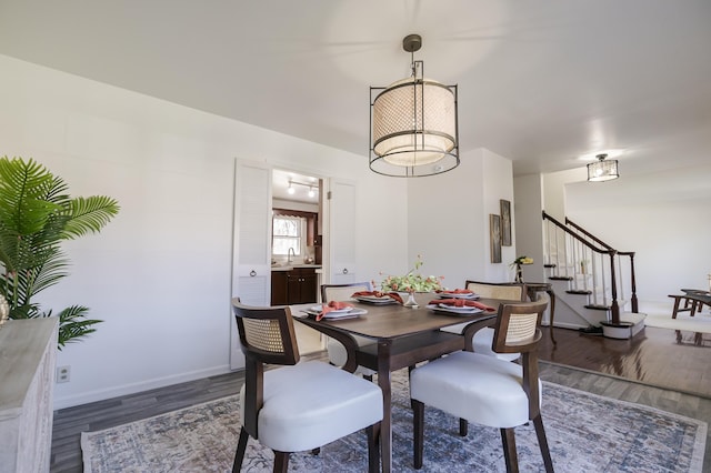 16230 Woodcrest Dr, Spring Lake, MI 49456 - dining area featuring baseboards, wood finished floors, and stairway