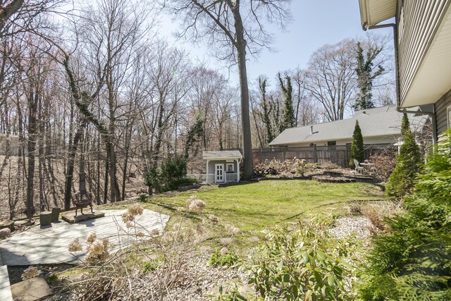 16230 Woodcrest Dr, Spring Lake, MI 49456 - view of yard featuring an outbuilding, a patio, and fence