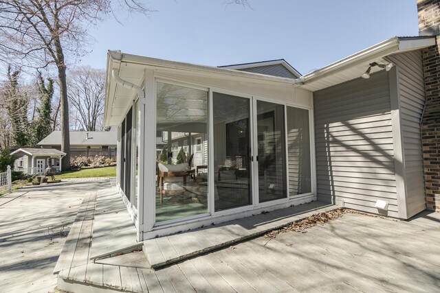 16230 Woodcrest Dr, Spring Lake, MI 49456 - exterior space featuring brick siding, a sunroom, and a deck