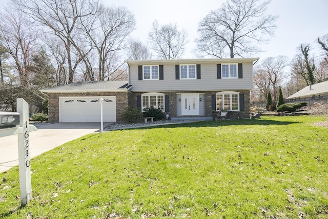 16230 Woodcrest Dr, Spring Lake, MI 49456 - colonial house with a front lawn, driveway, brick siding, and a garage