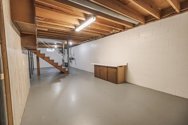 16230 Woodcrest Dr, Spring Lake, MI 49456 - unfinished basement featuring stairway and concrete block wall