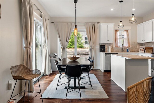 16325 Stones Throw Ln, Union Pier, MI 49129 - kitchen featuring stainless steel dishwasher, decorative backsplash, light countertops, white cabinetry, and a kitchen island
