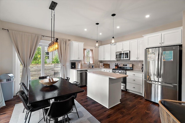 16325 Stones Throw Ln, Union Pier, MI 49129 - kitchen with light countertops, backsplash, a kitchen island, and stainless steel appliances