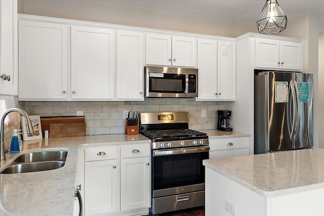 16325 Stones Throw Ln, Union Pier, MI 49129 - kitchen with light stone counters, a sink, white cabinetry, backsplash, and appliances with stainless steel finishes