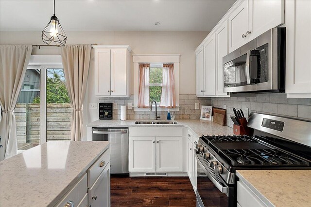 16325 Stones Throw Ln, Union Pier, MI 49129 - kitchen featuring white cabinets, dark wood-style floors, a sink, decorative backsplash, and appliances with stainless steel finishes