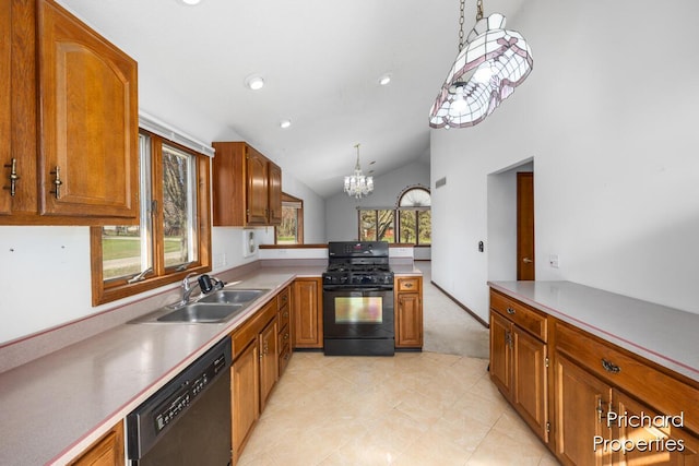 kitchen featuring brown cabinets, decorative light fixtures, a sink, and black appliances