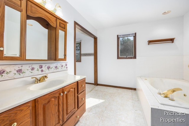 full bathroom featuring baseboards, a garden tub, vanity, and tile patterned flooring