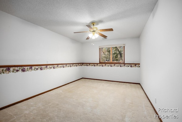 spare room with baseboards, carpet, and ceiling fan