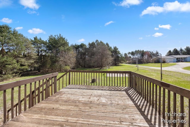 wooden deck with a lawn
