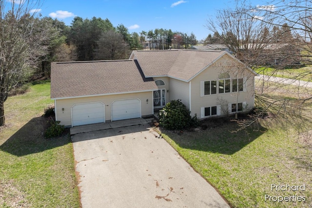 view of front of home with an attached garage, a shingled roof, a front yard, and concrete driveway