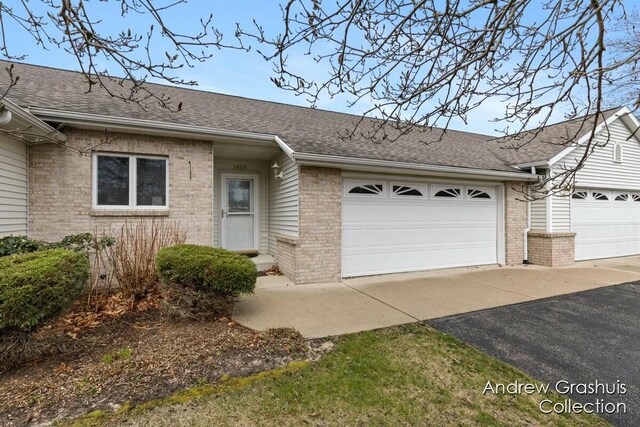 1650 Parker Dr Unit 20, Wayland, MI 49348 - ranch-style house with brick siding, aphalt driveway, roof with shingles, and a garage