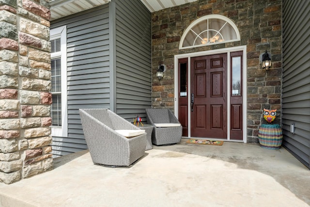 view of exterior entry featuring stone siding