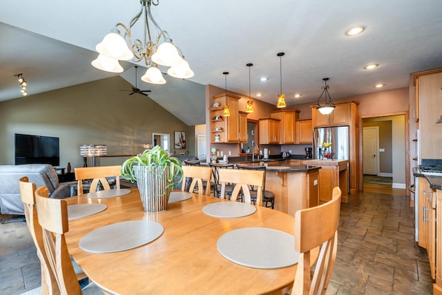 dining space featuring recessed lighting, ceiling fan with notable chandelier, stone finish floor, and lofted ceiling