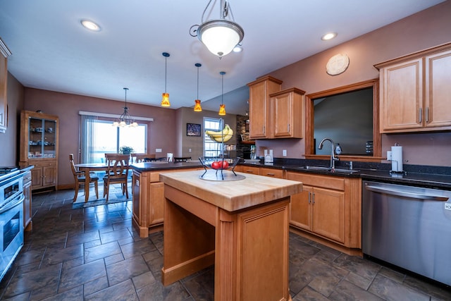kitchen featuring stainless steel dishwasher, stone tile flooring, a kitchen island, wooden counters, and a sink