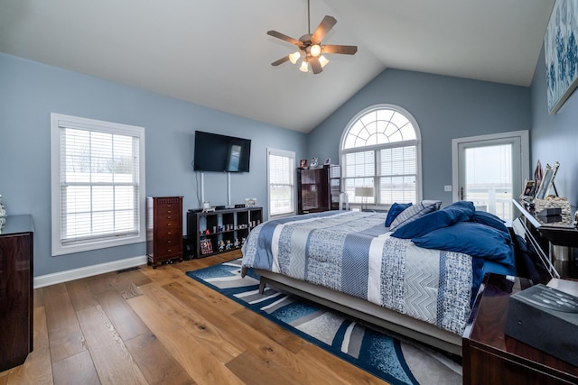 bedroom featuring lofted ceiling, hardwood / wood-style floors, a ceiling fan, and baseboards