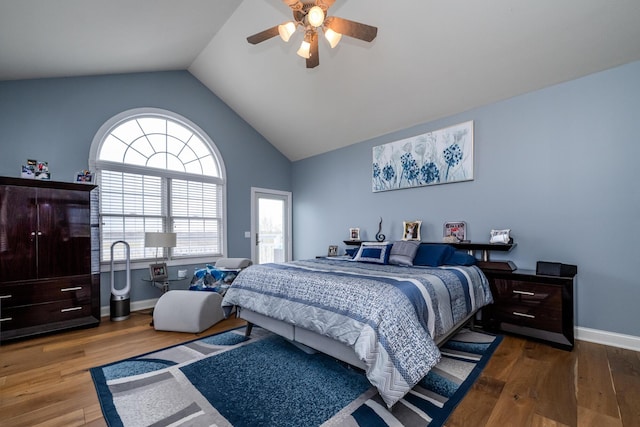 bedroom featuring lofted ceiling, wood finished floors, and multiple windows