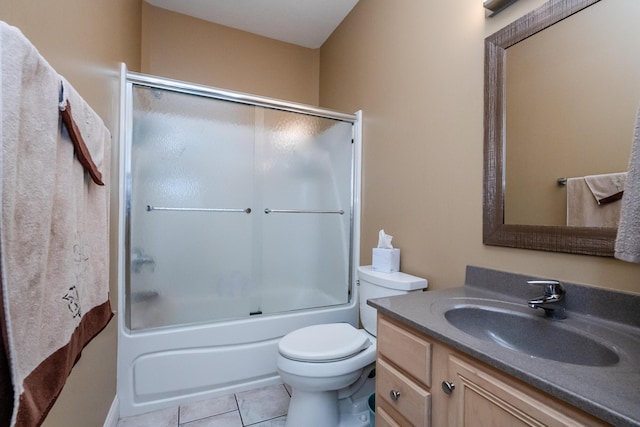 full bathroom featuring tile patterned floors, toilet, vanity, and shower / bath combination with glass door