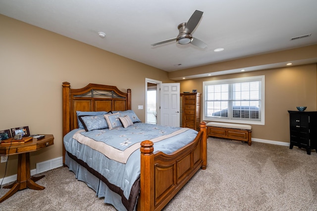 bedroom with light colored carpet, visible vents, ceiling fan, and baseboards