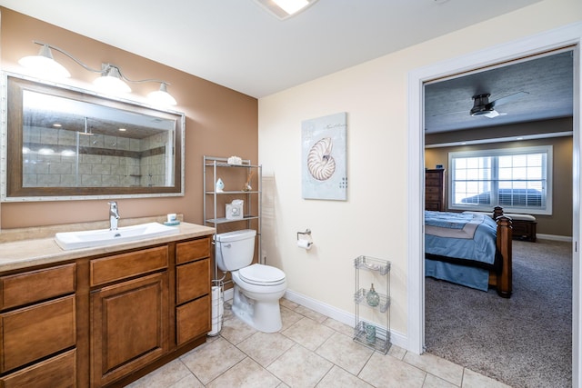 bathroom featuring toilet, vanity, tile patterned floors, and baseboards