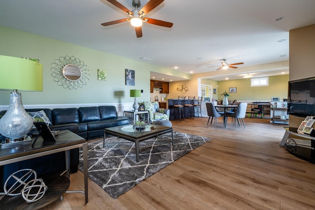 living room with visible vents, wood finished floors, a ceiling fan, and recessed lighting