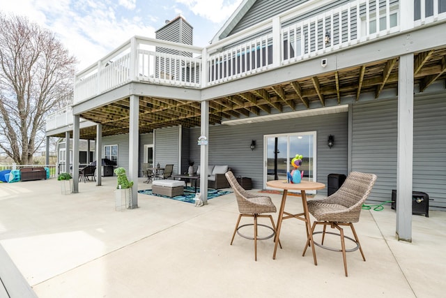 view of patio / terrace with a wooden deck and outdoor dining area