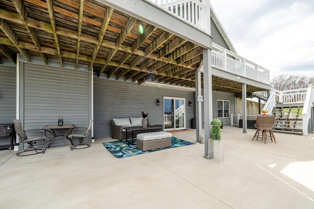 view of patio featuring an outdoor living space, stairway, and a wooden deck