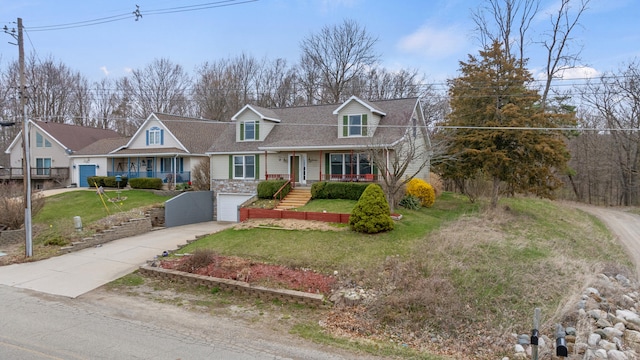 10951 N Waldron Rd, Jerome, MI 49249 - new england style home with concrete driveway, a porch, a front yard, stone siding, and a garage