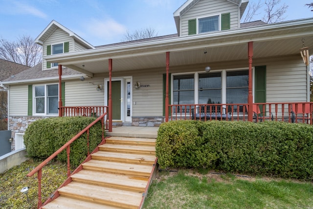 10951 N Waldron Rd, Jerome, MI 49249 - view of front facade with stone siding, covered porch, and a shingled roof