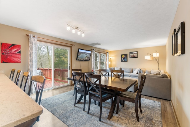 10951 N Waldron Rd, Jerome, MI 49249 - dining space featuring wood finished floors and a textured ceiling