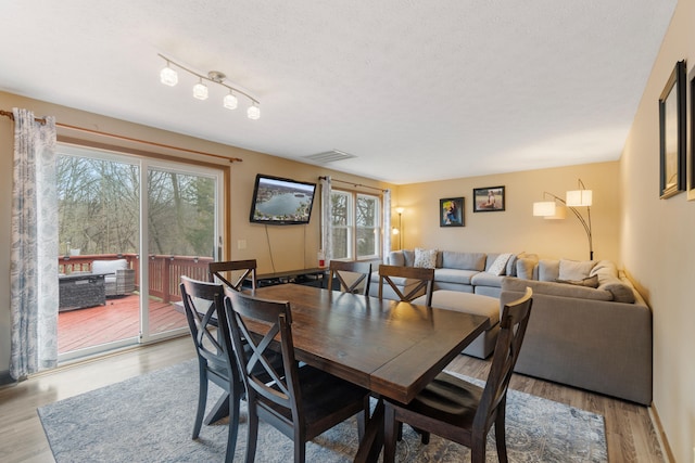 10951 N Waldron Rd, Jerome, MI 49249 - dining area with wood finished floors, a textured ceiling, and visible vents