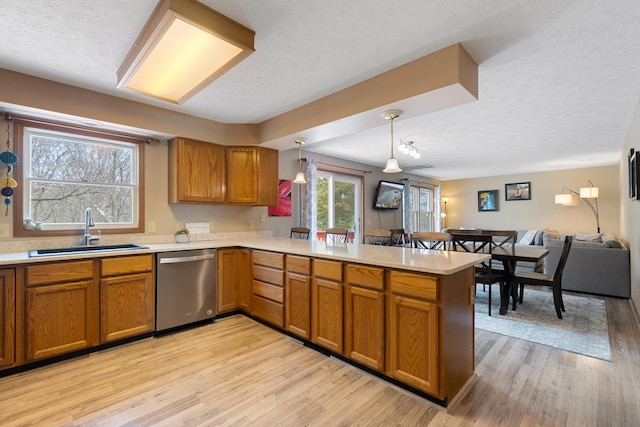 10951 N Waldron Rd, Jerome, MI 49249 - kitchen with a peninsula, stainless steel dishwasher, a sink, and a textured ceiling