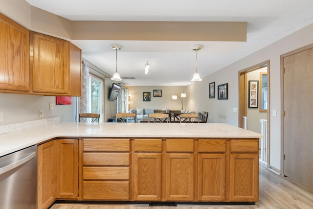 10951 N Waldron Rd, Jerome, MI 49249 - kitchen featuring stainless steel dishwasher, hanging light fixtures, open floor plan, light wood-style floors, and a peninsula