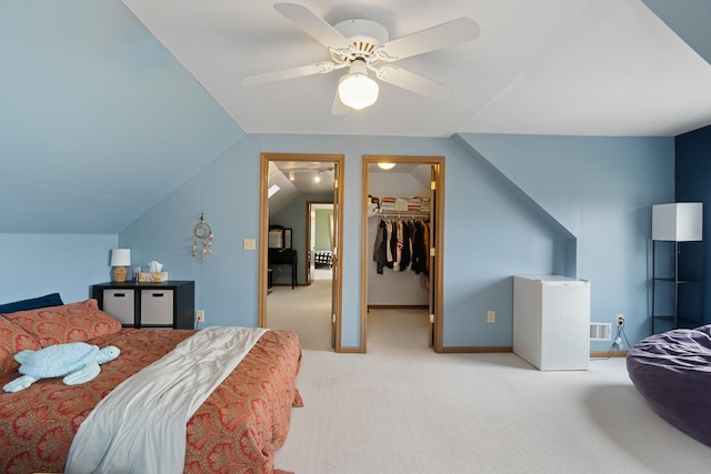 10951 N Waldron Rd, Jerome, MI 49249 - bedroom featuring visible vents, lofted ceiling, a ceiling fan, carpet floors, and a walk in closet