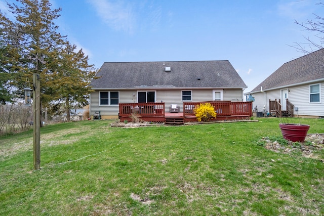 10951 N Waldron Rd, Jerome, MI 49249 - rear view of house featuring a wooden deck, a shingled roof, and a yard