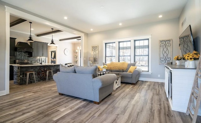 8477 84th St SE, Alto, MI 49302 - living room featuring beam ceiling, baseboards, visible vents, recessed lighting, and wood finished floors