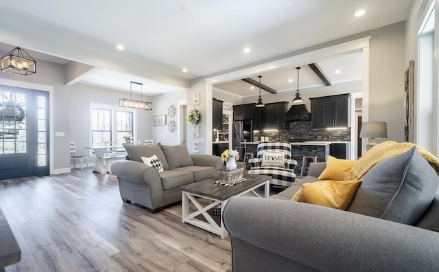 8477 84th St SE, Alto, MI 49302 - living room with recessed lighting, light wood-type flooring, and an inviting chandelier