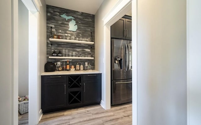 8477 84th St SE, Alto, MI 49302 - bar with decorative backsplash, a dry bar, light wood-style flooring, and stainless steel fridge with ice dispenser