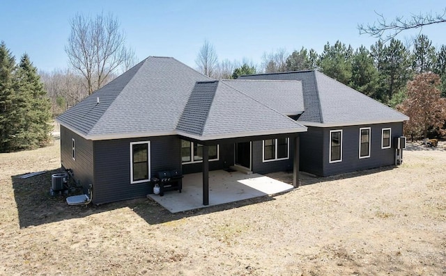 8477 84th St SE, Alto, MI 49302 - rear view of property featuring roof with shingles, a patio, and central AC unit