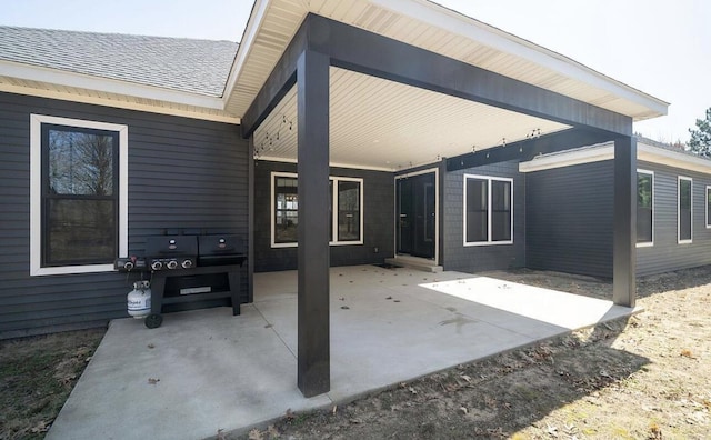 8477 84th St SE, Alto, MI 49302 - rear view of property with a shingled roof and a patio