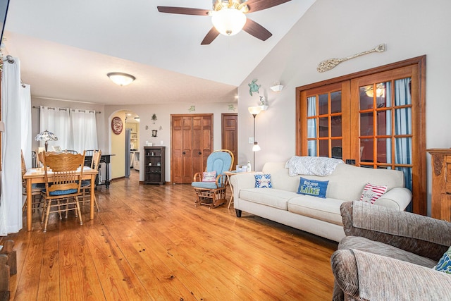 66100 Dolans Ave, Vandalia, MI 49095 - living area featuring high vaulted ceiling, ceiling fan, arched walkways, and light wood-type flooring