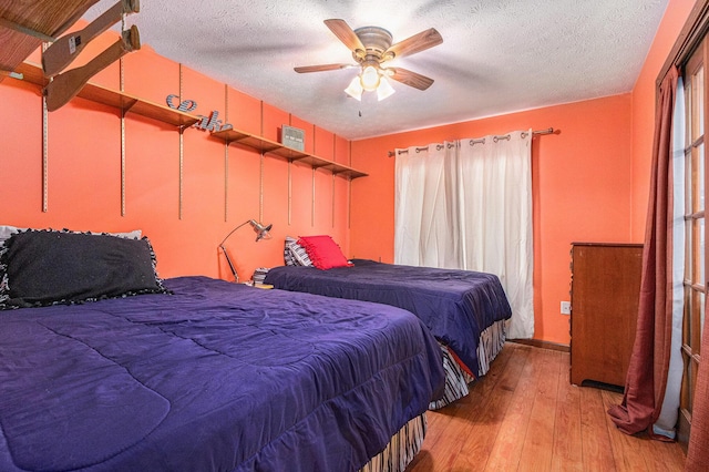 66100 Dolans Ave, Vandalia, MI 49095 - bedroom with a textured ceiling, light wood-style floors, and ceiling fan